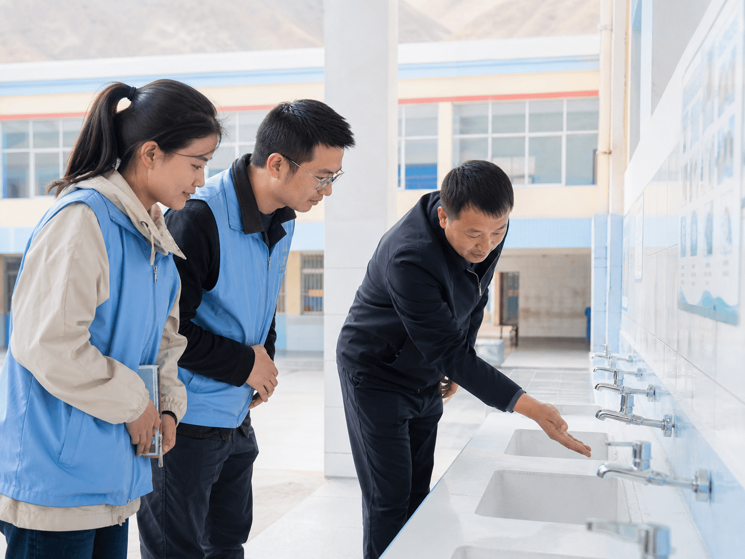 Community volunteers reviewing a school handwashing facility